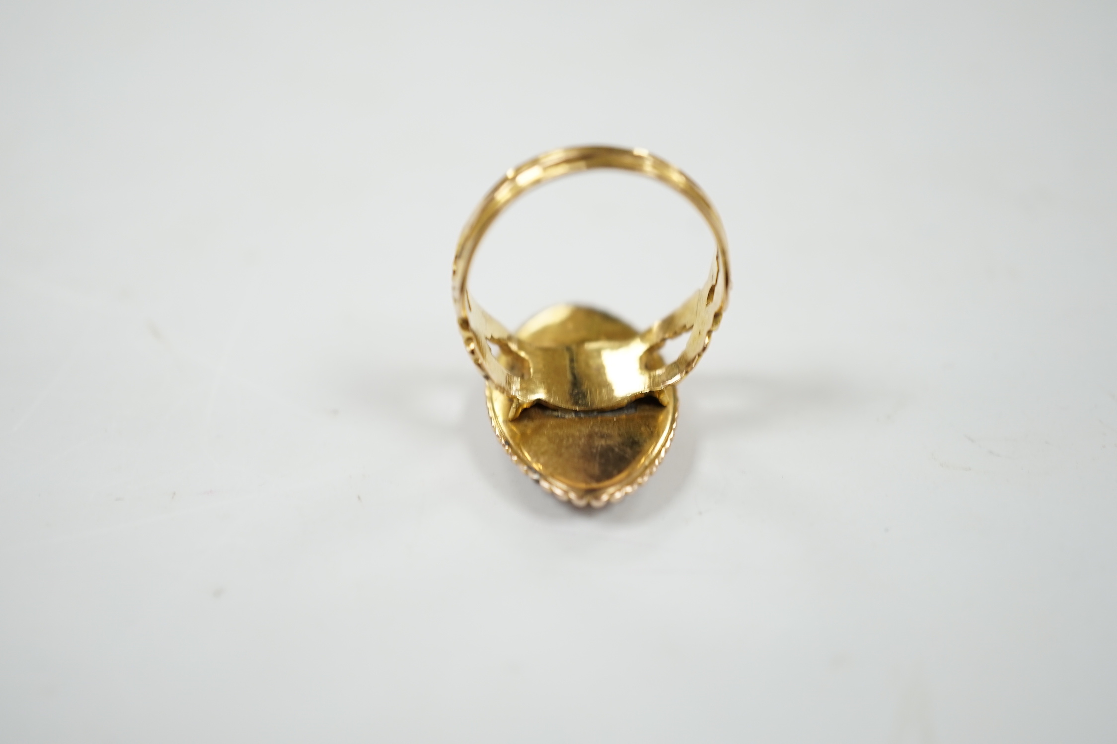 A 19th century 15ct and blue enamel set navette shaped mourning ring, with damaged inset ivory panel, size O, gross weight 5.5 grams. Submission reference Q8ZGC6ZR